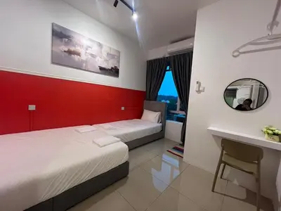 a hotel room with two beds and a mirror at RedHouse Sky Garden Klabang in Ipoh