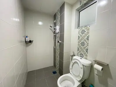 a bathroom with a toilet and a shower at The Anderson Ipoh Town in Ipoh