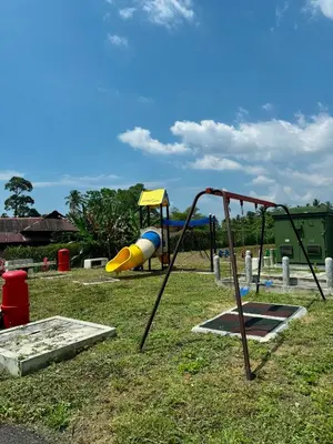 a park with a playground with a slide at Haneya Homestay in Kampong Banggol Pasir