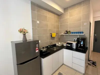 a small kitchen with a refrigerator and a sink at ICC Suites Ipoh Walking distance to Mall in Ipoh