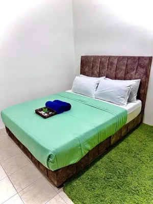 a bed with a brown headboard with a tray on it at Lapang Tuju Private Pool Homestay in Sungai Petani