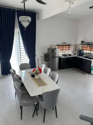 a kitchen and dining room with a table and chairs at Lapang Tuju Private Pool Homestay in Sungai Petani