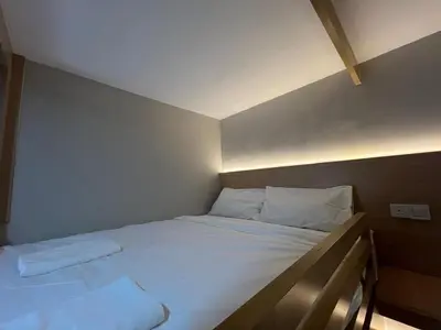 a bedroom with a bed with white sheets and pillows at PrimaStay Ipoh Palo for 7 Pax in Ipoh