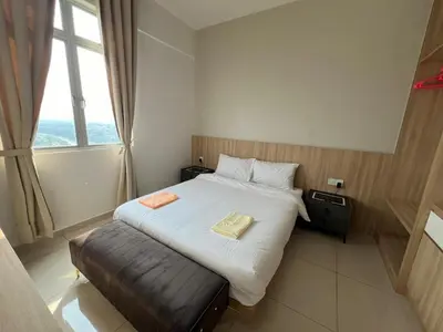 a bedroom with a large bed with a large window at PrimaStay Ipoh Palo for 7 Pax in Ipoh