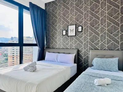 a bedroom with two beds with a teddy bear on them at sea city cozy familystay 3br 10 pax in George Town