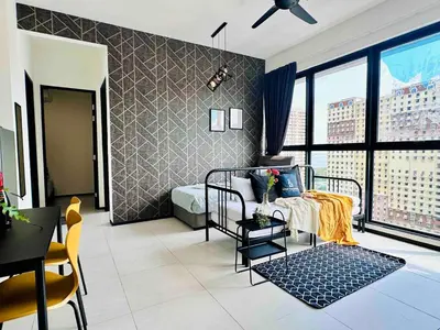 a bedroom with a bed and a large window at Urban suites 3BR 10pax in George Town
