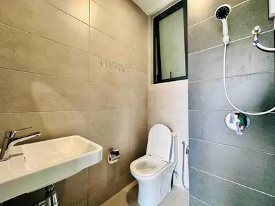 a small bathroom with a toilet and a sink at Urban suites 3BR 10pax in George Town