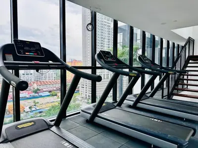a row of treadmills in a gym with a window at Island Sea & City View Familystay 3BR 10Pax in George Town
