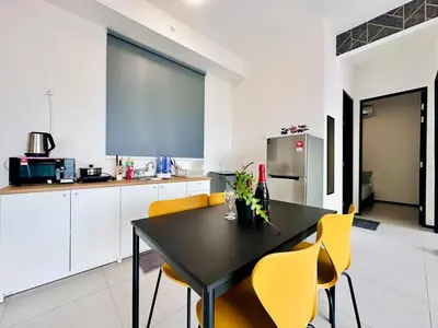 a kitchen with a black table and yellow chairs at Island Sea & City View Familystay 3BR 10Pax in George Town