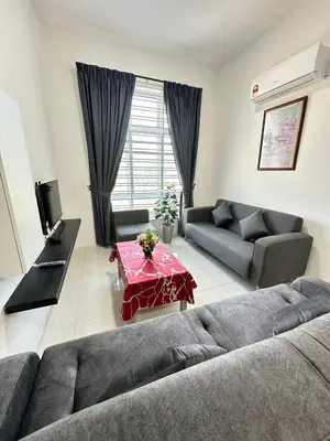 a living room with a couch and a table at zamanss homestay in Kampong Simee