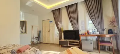 a bedroom with a bed and a desk with a television at CBHResort Agrofarm in Baling