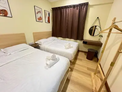 a hotel room with two beds and a window at G Home 2 - Ipoh City Centre The Majestic 2R2B in Ipoh