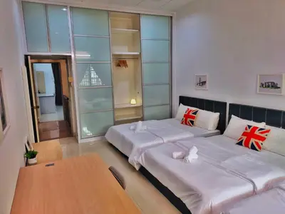 a room with two beds and a table at Semi-Detached, Up to 24 Pax, 3200sqft, 4 Bedrooms, 3 Bathrooms, 4 Car Parks by Star Home in Gelugor