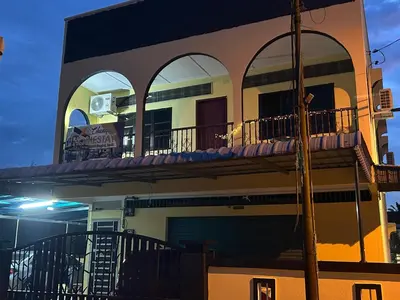 a building with two balconies on top of it at Chengai homestay in Sungkai