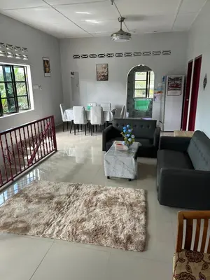 a living room with a couch and a table at Chengai homestay in Sungkai