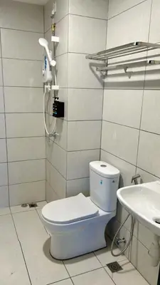 a bathroom with a toilet and a sink at Lavender Villa Marc Residence Bukit Mertajam in Bukit Mertajam