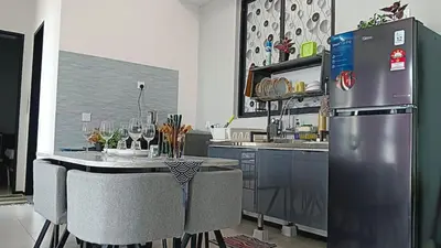 a kitchen with a refrigerator and a table with chairs at Royal Luxury apartment in Georgetown 3BR 10PAX in George Town