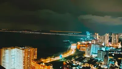 a view of a city at night with a bridge at Royal Luxury apartment in Georgetown 3BR 10PAX in George Town