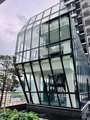 a glass office building with a large window at Sea & City View New Condo in Georgetown 3br 10 pax in George Town