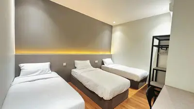 a small room with two beds in it at Legend Inn Sungai Petani in Sungai Petani