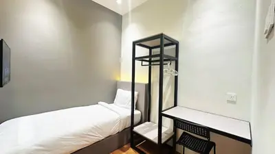 a small room with a bed and a shelf at Legend Inn Sungai Petani in Sungai Petani