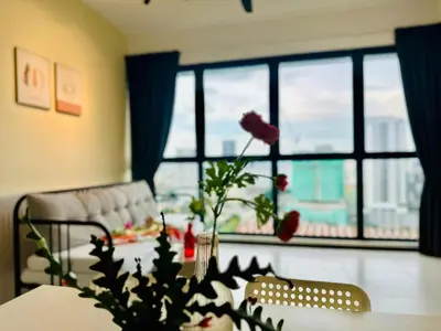 a living room with a table with a flower on it at cozy family stay suites apartment 3br 10 pax in George Town
