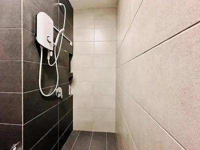 a bathroom with a shower with a phone on the wall at cozy family stay urban suite 3br 10 pax in George Town