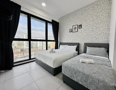 a bedroom with two beds and a large window at luxury apartment 3br 10 pax in George Town