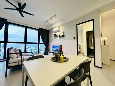 a living room with a white table and chairs at 15 min airport to apartment 3br 10pax in George Town