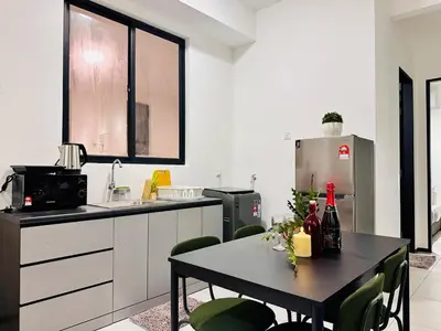 a kitchen with a table with bottles of wine on it at UB suite aparment for food hunter 3br 10 pax in George Town