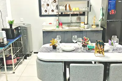 a kitchen with a table with glasses on it at Rooftop Penang View & infinity pool suite apartment 3br 10 pax in George Town