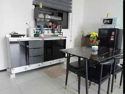 a kitchen with a black table and chairs in a kitchen at Rooftop Penang View & infinity pool suite apartment 3br 10 pax in George Town