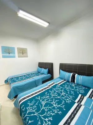 two beds sitting next to each other in a room at Wanie CH Homestay 1 Brinchang Cameron Highlands in Brinchang