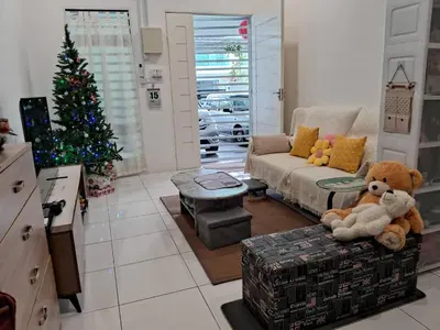 a living room with a christmas tree and a teddy bear at HEE & PENNIE House in Ipoh