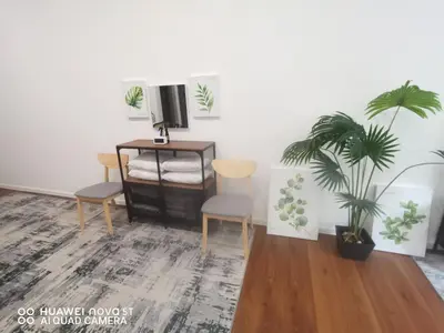 a living room with two chairs and a television at Belladira Homestay CH in Brinchang