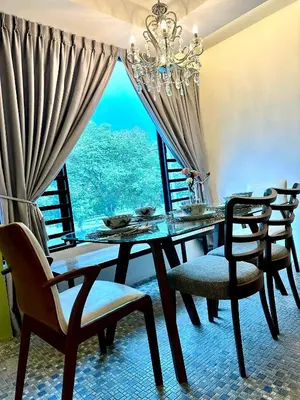 a dining room with a table and chairs and a window at Ipoh Garden Canning Very Near Food Desire Homestay in Ipoh