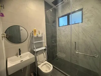 a bathroom with a toilet and a sink and a shower at Zhara Homestay in Ipoh