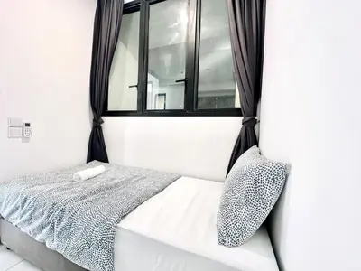 a bed in a room with a window at Urban Rooftop veiw PENANG 3br 10 pax in Jelutong