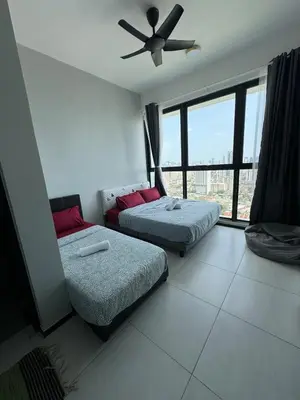 a bedroom with two beds and a ceiling fan at Urban Rooftop veiw PENANG 3br 10 pax in Jelutong