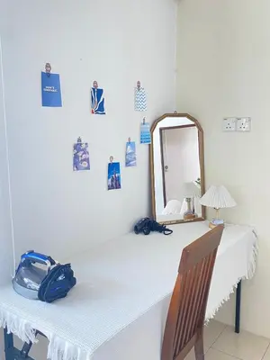 a white table with a mirror and a blue bag on it at 8 pax KakaHomestay Tmn Petani Jaya in Sungai Petani