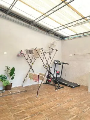 a room with a gym with a bike and a treadmill at 8 pax KakaHomestay Tmn Petani Jaya in Sungai Petani