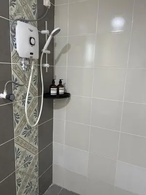 a shower with a shower head in a bathroom at Ipoh Cozy Stay Near Town & Park in Ipoh