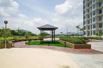 a gazebo in a park next to a building at Ipoh Cozy Stay Near Town & Park in Ipoh