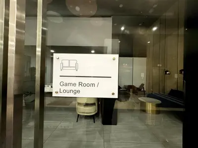 a sign that says game room and lounge on a window at Stunning Luxury Breathtaking Sea & City Views 3BR 12PAX in Jelutong