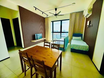 a room with a table and a bed and a bedroom at Luxury Sea & City Views 3BR 12PAX in Jelutong