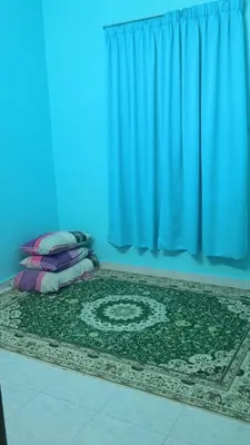 a blue room with a rug and a blue curtain at Homestay RestUI, Kepala Batas Penang, 4km dari Tol Bertam in Kepala Batas