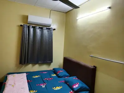 a bedroom with a bed with a bedspread with cars on it at Krishna Villa in Simpang