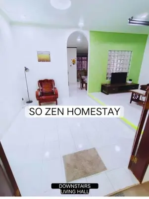 a living room with green walls and a room with a couch at So Zen Homestay in Taiping