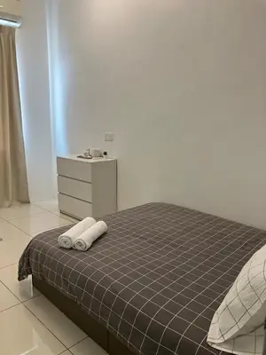 a bedroom with a bed with two towels on it at Chicken Little 4-bedroom home with free parking! Available for Business Trip in Kampong Lima Kongsi