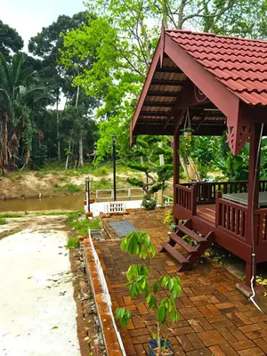 a pavilion with a table and benches in a park at Homestay Desa Kati Kuala Kangsar in Kuala Kangsar